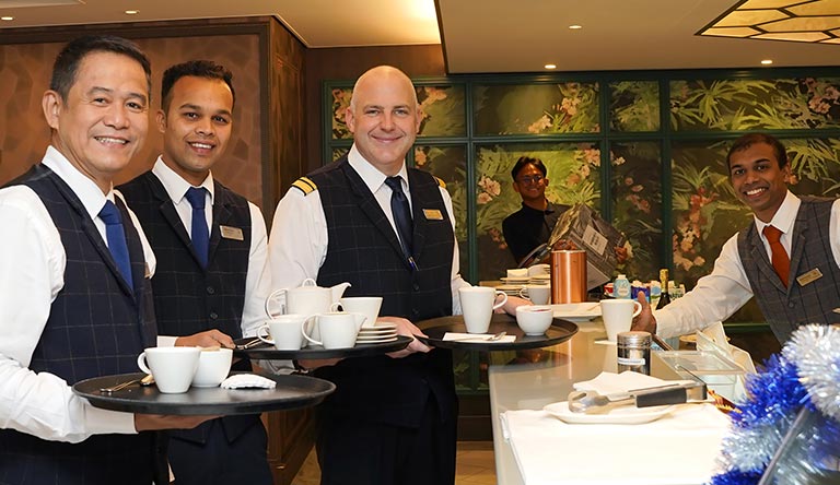 Captain Steve James with staff in the Living Room